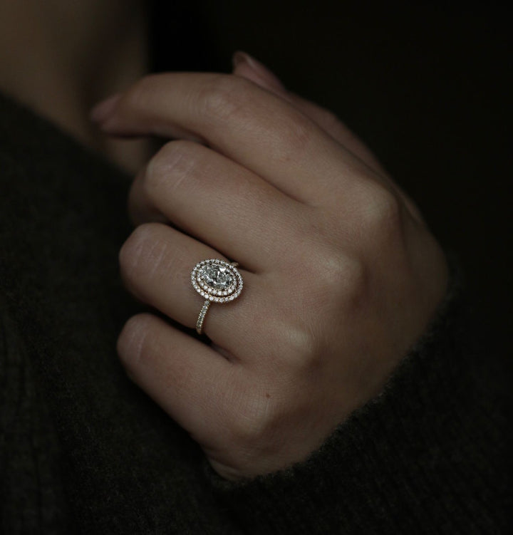 Oval cut halo engagement ring shown in real-life wear