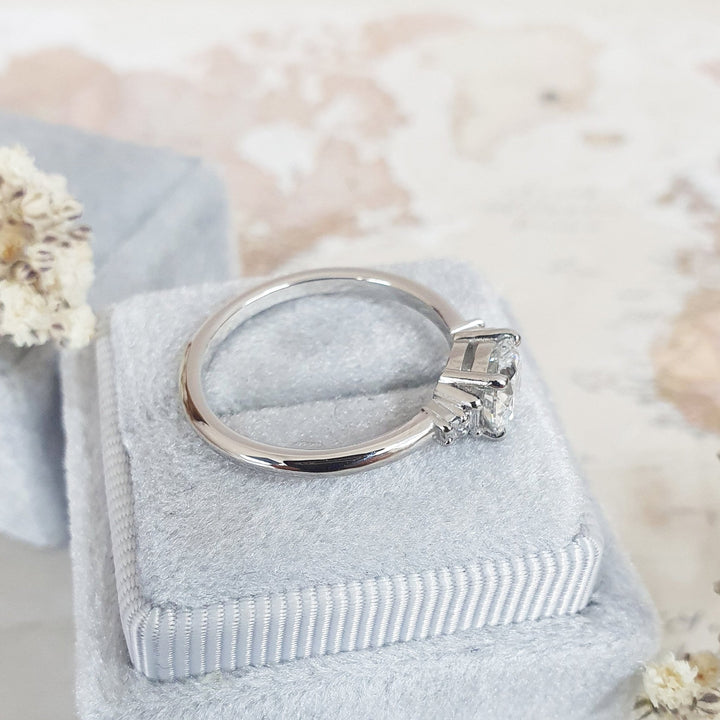Round five stone engagement ring shown on hand for true-to-life sizing