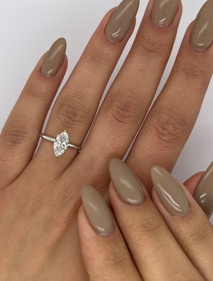 Marquise solitaire engagement ring close-up showing F/VS2 diamond clarity