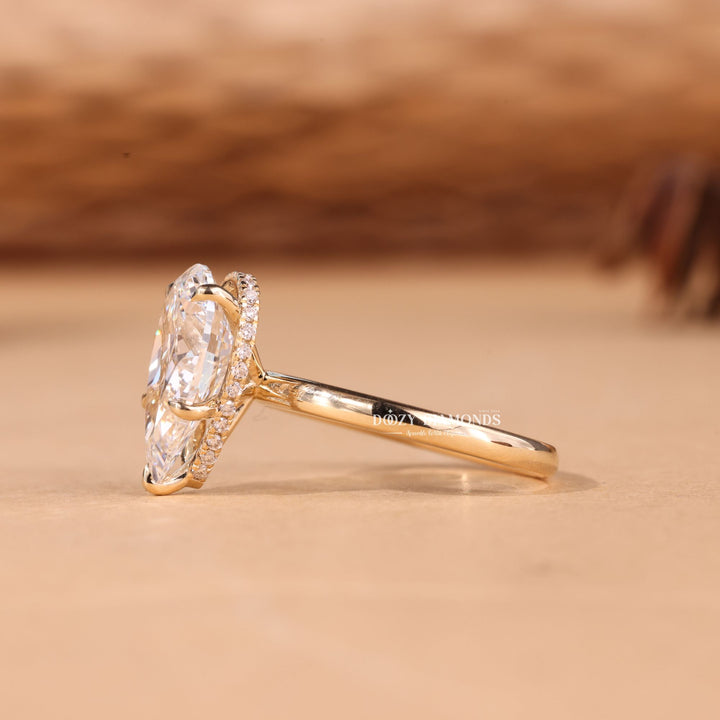 Pear hidden halo engagement ring photographed in natural light