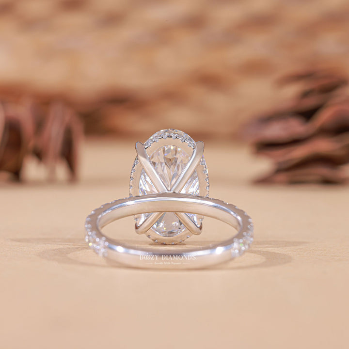 Certified oval cut diamond featured in hidden halo engagement ring