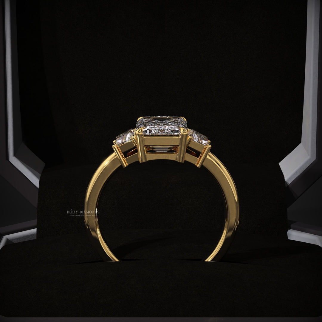 Emerald cut three stone engagement ring shown in real-life wear
