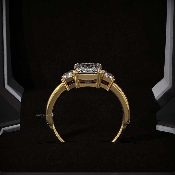 Emerald cut three stone engagement ring shown in real-life wear