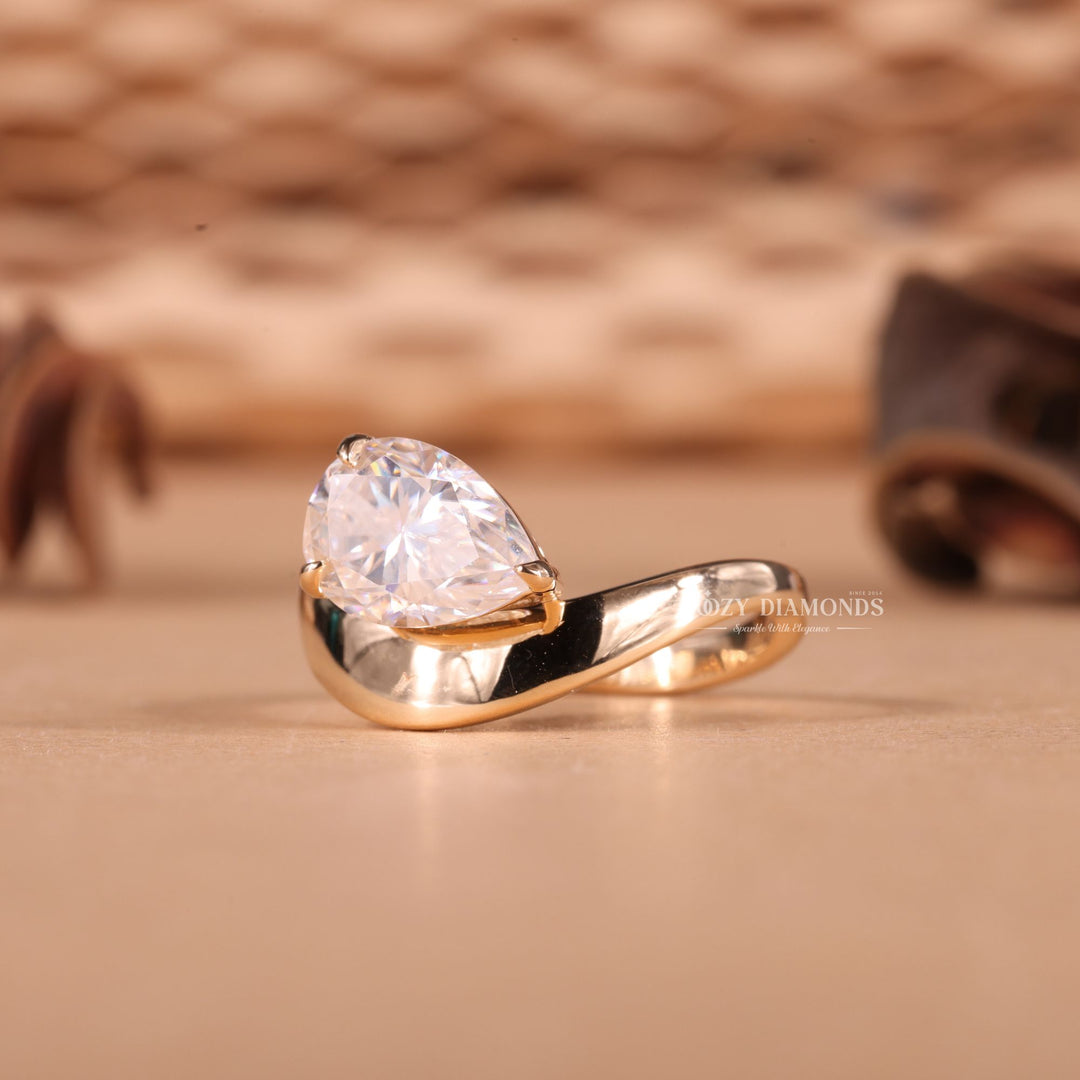 Pear east west engagement ring viewed from the side
