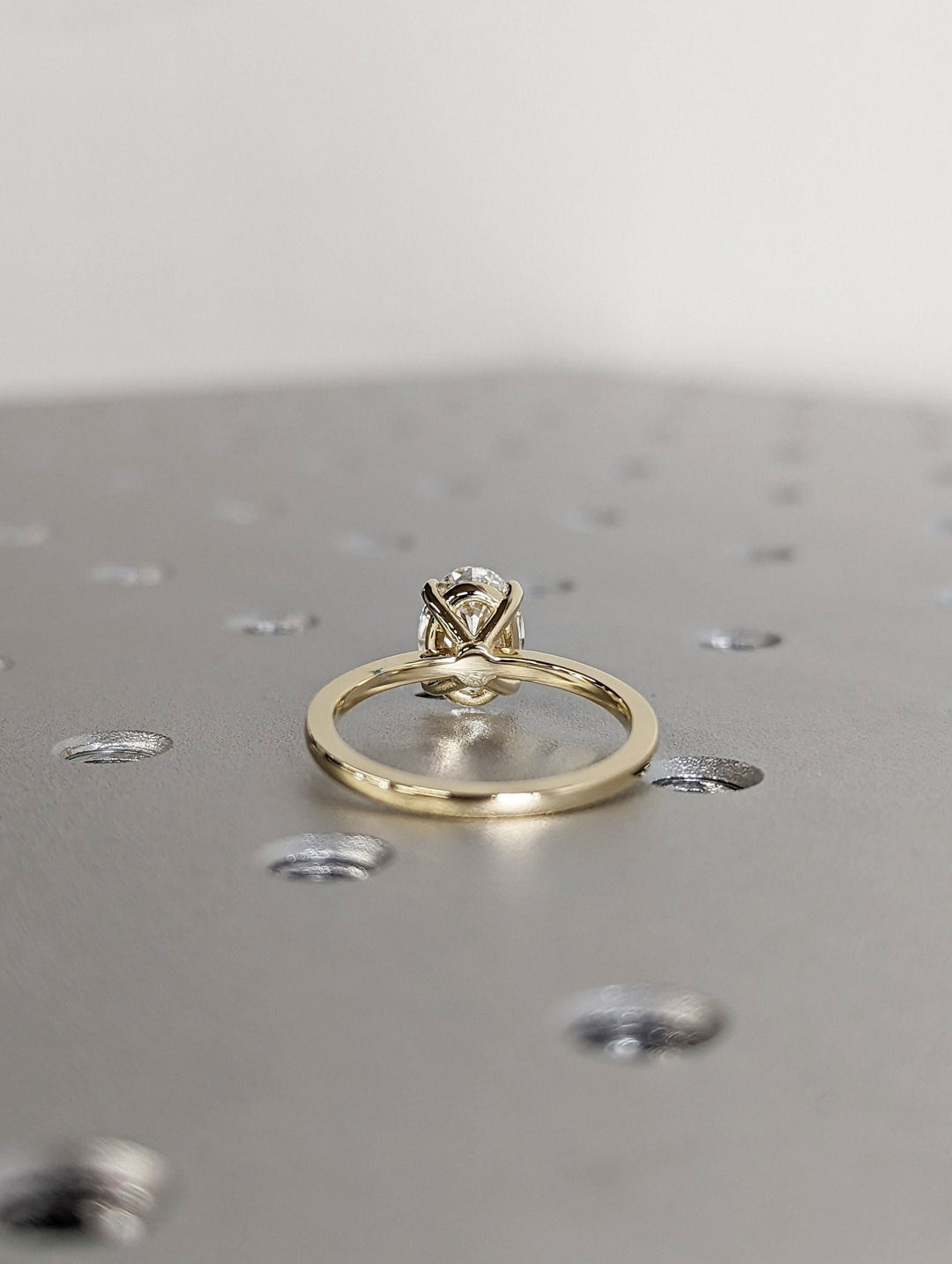 Lifestyle shot of oval solitaire diamond ring on hand