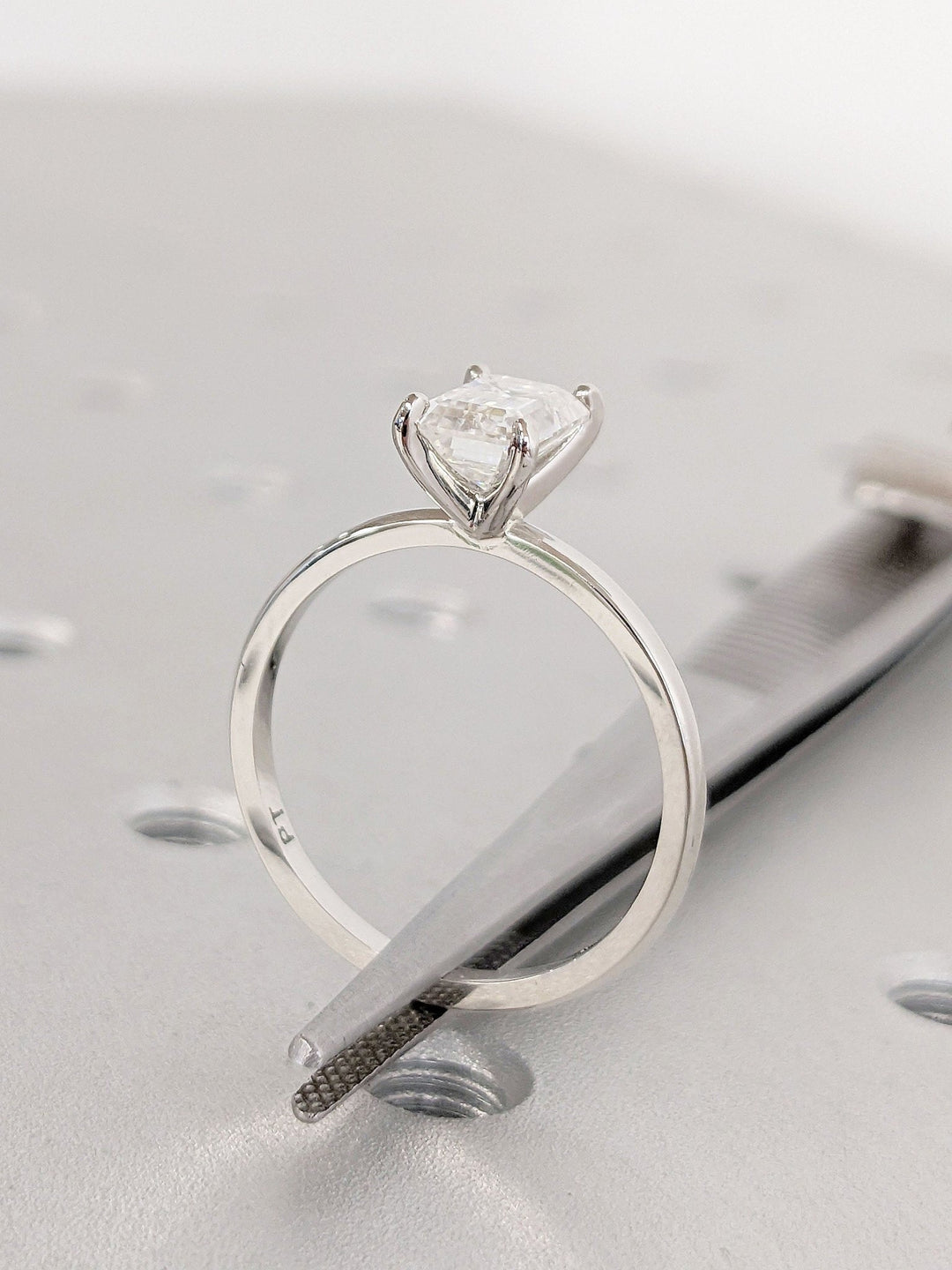 Side angle of emerald solitaire diamond engagement ring