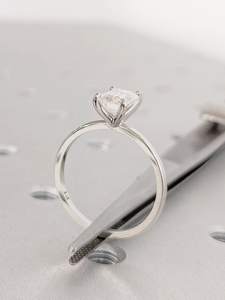 Side angle of emerald solitaire diamond engagement ring