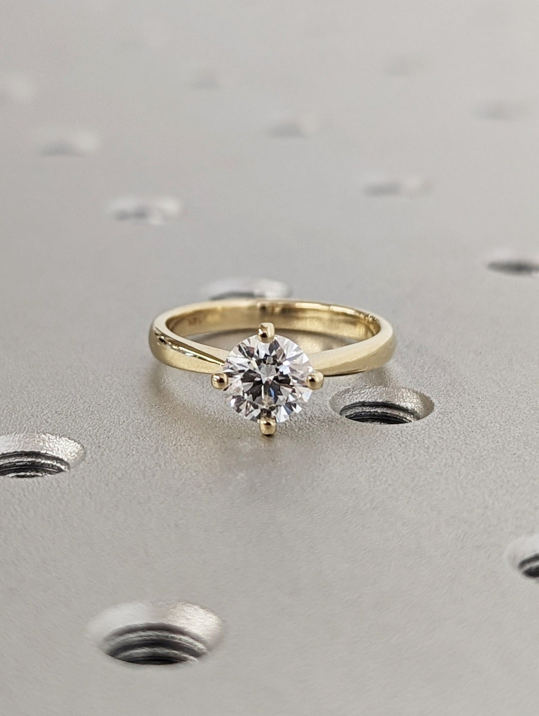 Close-up of round cut center diamond in solitaire engagement ring