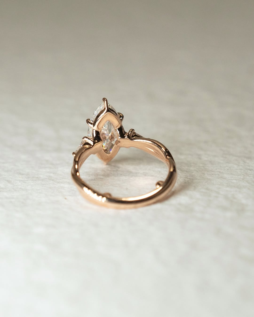 Marquise three stone engagement ring shown on hand for true-to-life sizing