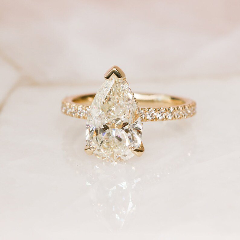 Pear hidden halo lab grown diamond ring side profile in gold setting