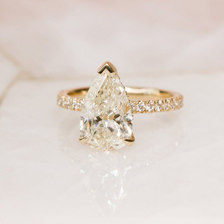 Pear hidden halo lab grown diamond ring side profile in gold setting