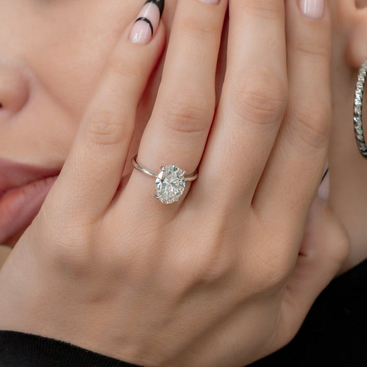 Angled view of oval cut diamond in hidden halo setting