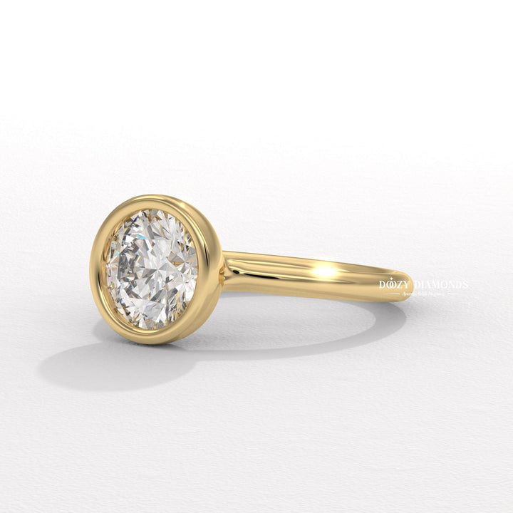 Certified round cut diamond featured in bezel engagement ring