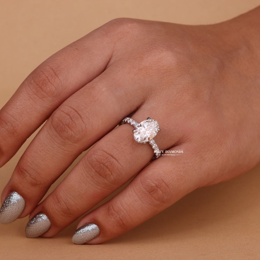 Oval hidden halo engagement ring close-up highlighting diamond sparkle