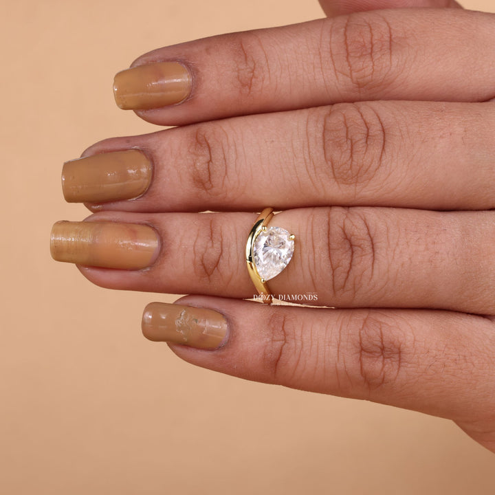 Lifestyle shot of pear dome diamond ring on hand