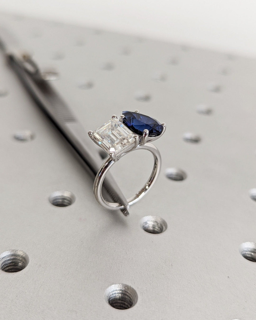 Emerald cut engagement ring shown with authenticity certificate