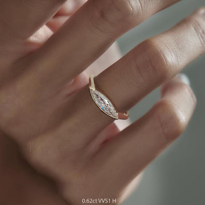 Close-up of marquise cut center diamond in solitaire engagement ring