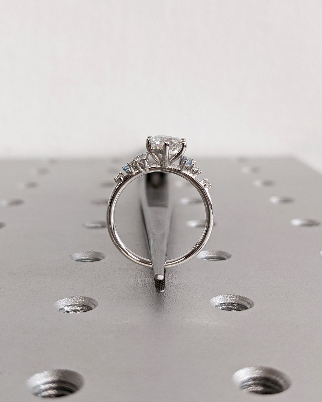 Round cluster engagement ring close-up highlighting diamond sparkle