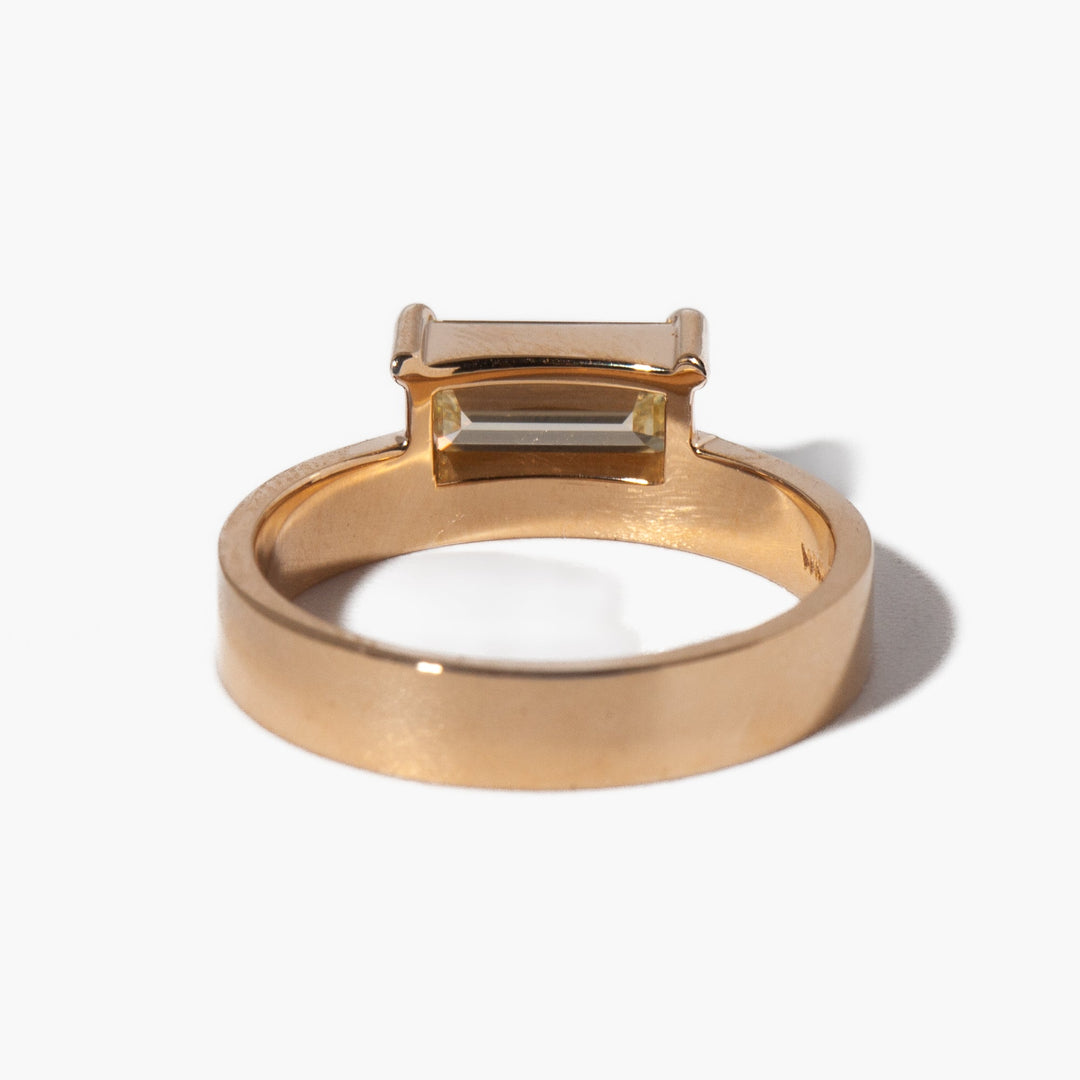 Angled view of emerald cut diamond in solitaire setting