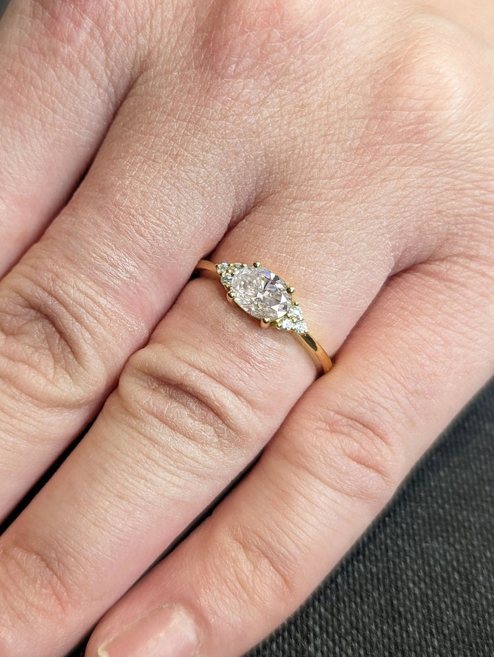 Oval cut engagement ring shown with authenticity certificate