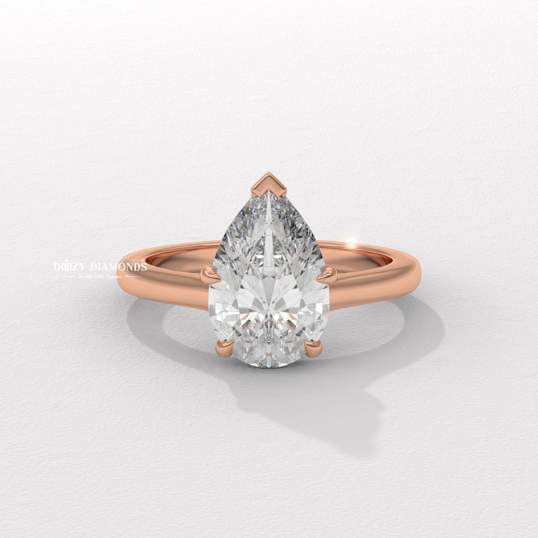 Pear solitaire diamond ring displayed on jewelry stand