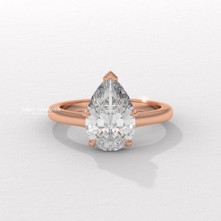 Pear solitaire diamond ring displayed on jewelry stand