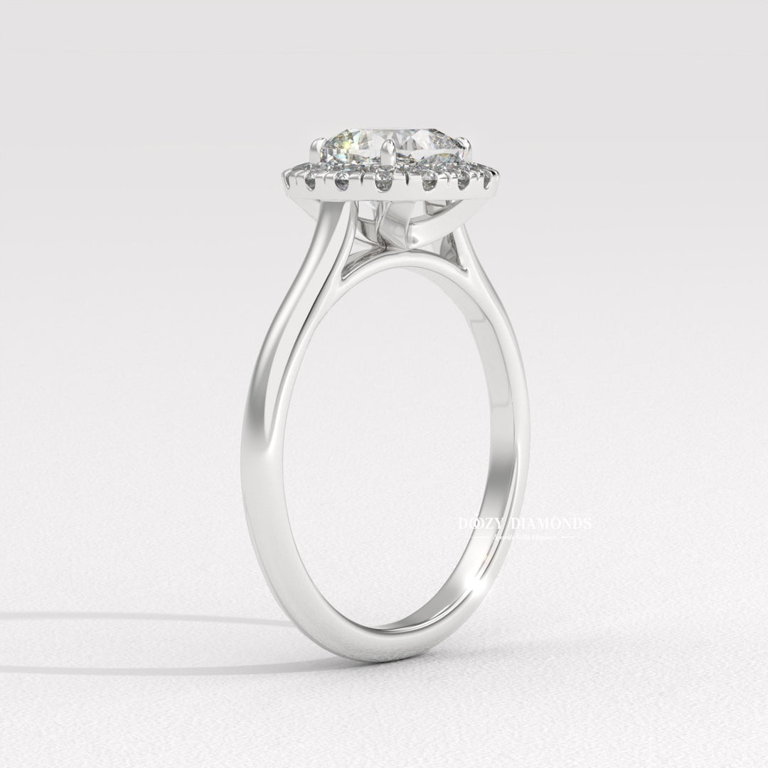 Cushion cut solitaire engagement ring shown in real-life wear