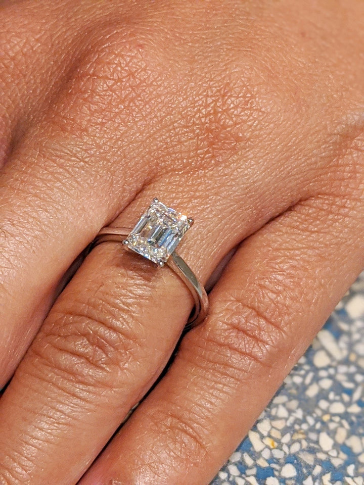 Emerald solitaire engagement ring finished in polished solid gold