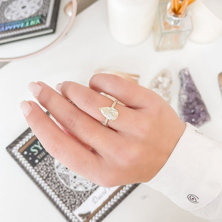 Side angle of pear hidden halo diamond engagement ring