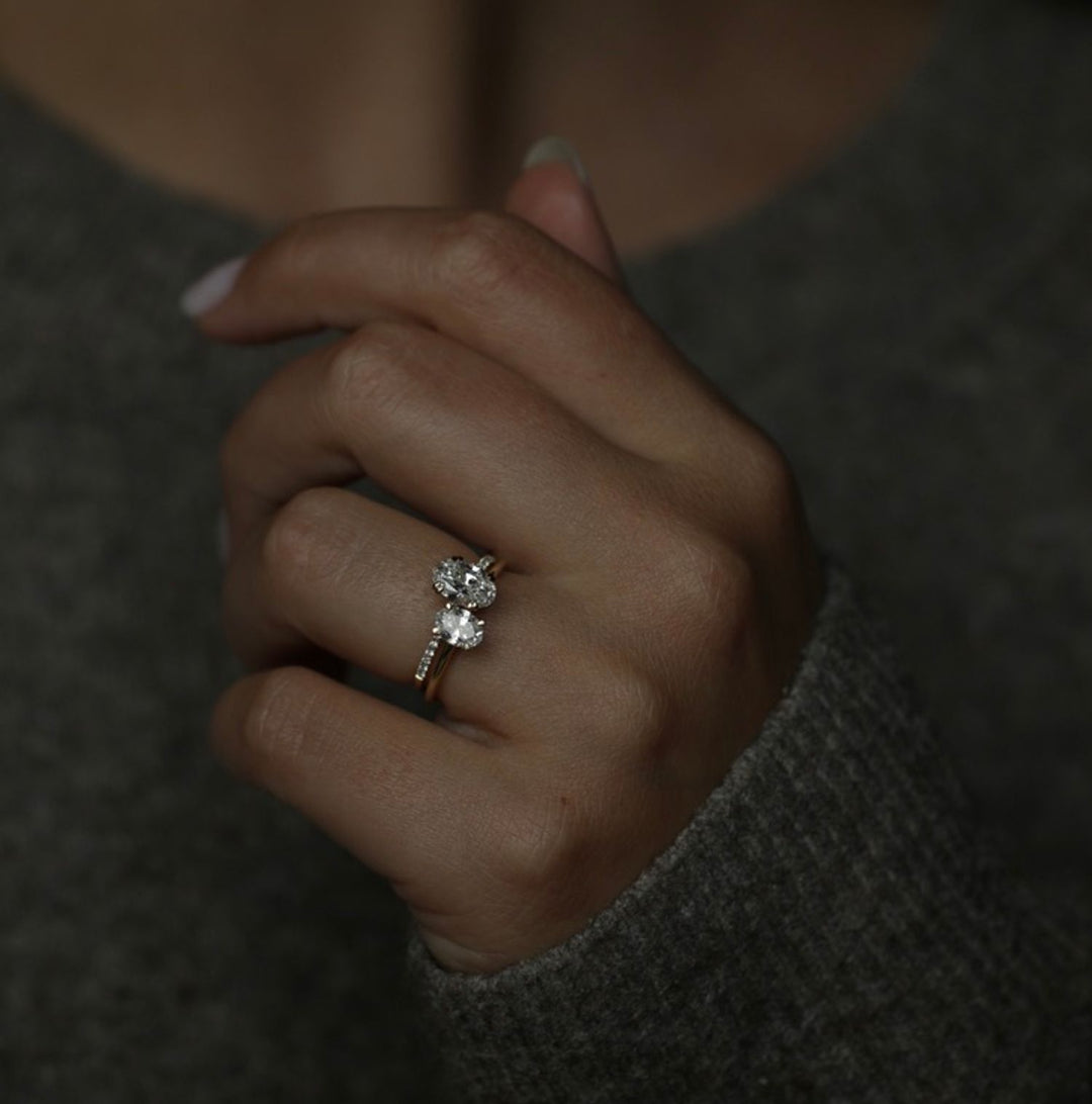 Lifestyle shot of oval solitaire diamond ring on hand
