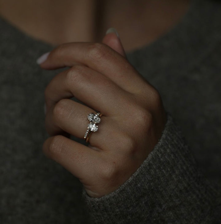Lifestyle shot of oval solitaire diamond ring on hand