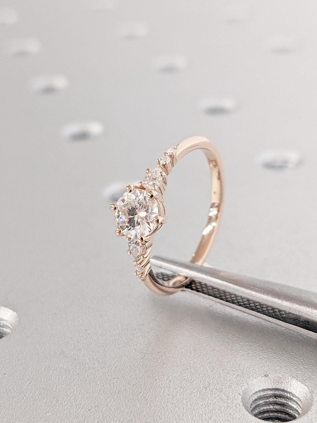 Round cut cluster engagement ring shown in real-life wear