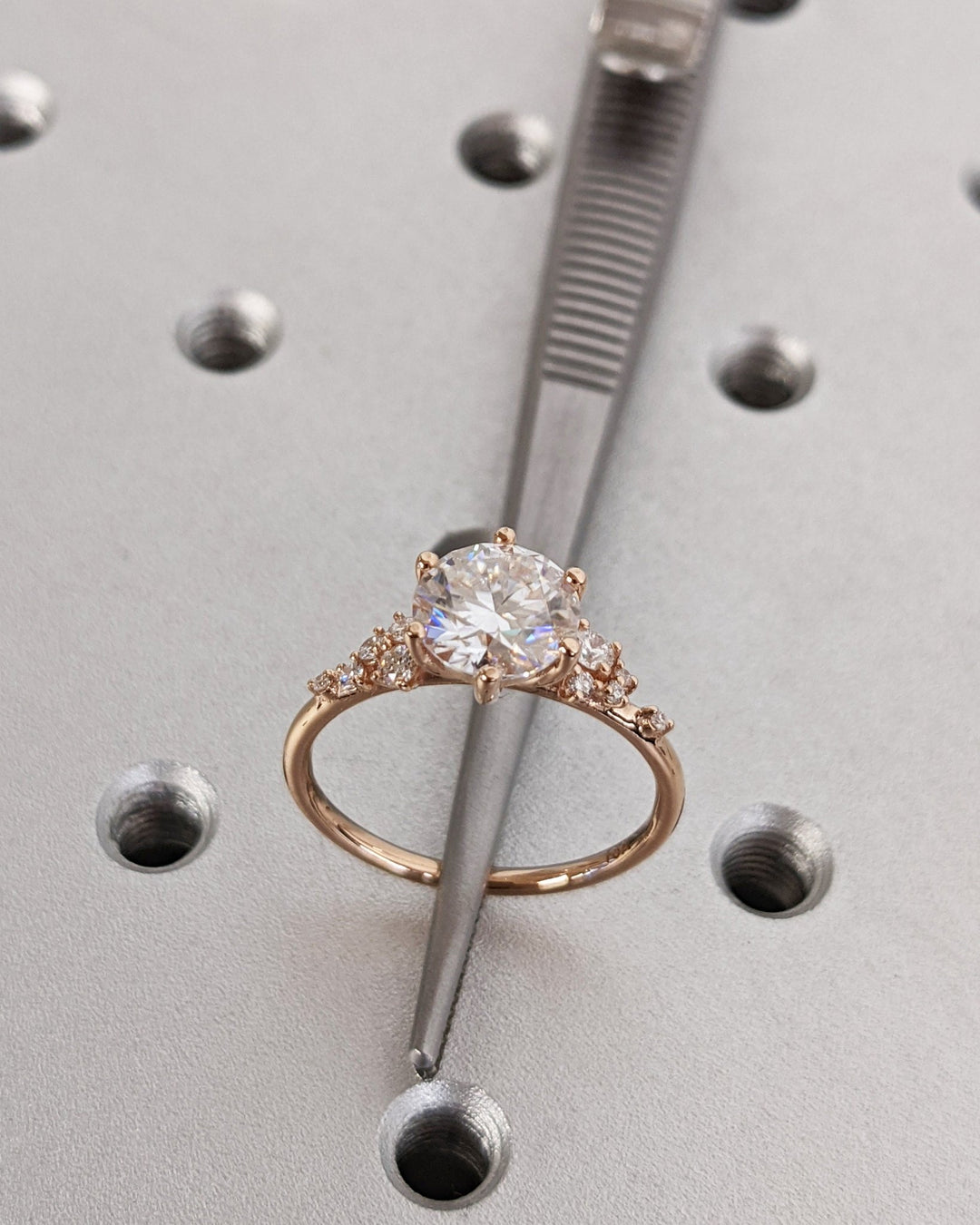 Round cut cluster engagement ring shown in real-life wear