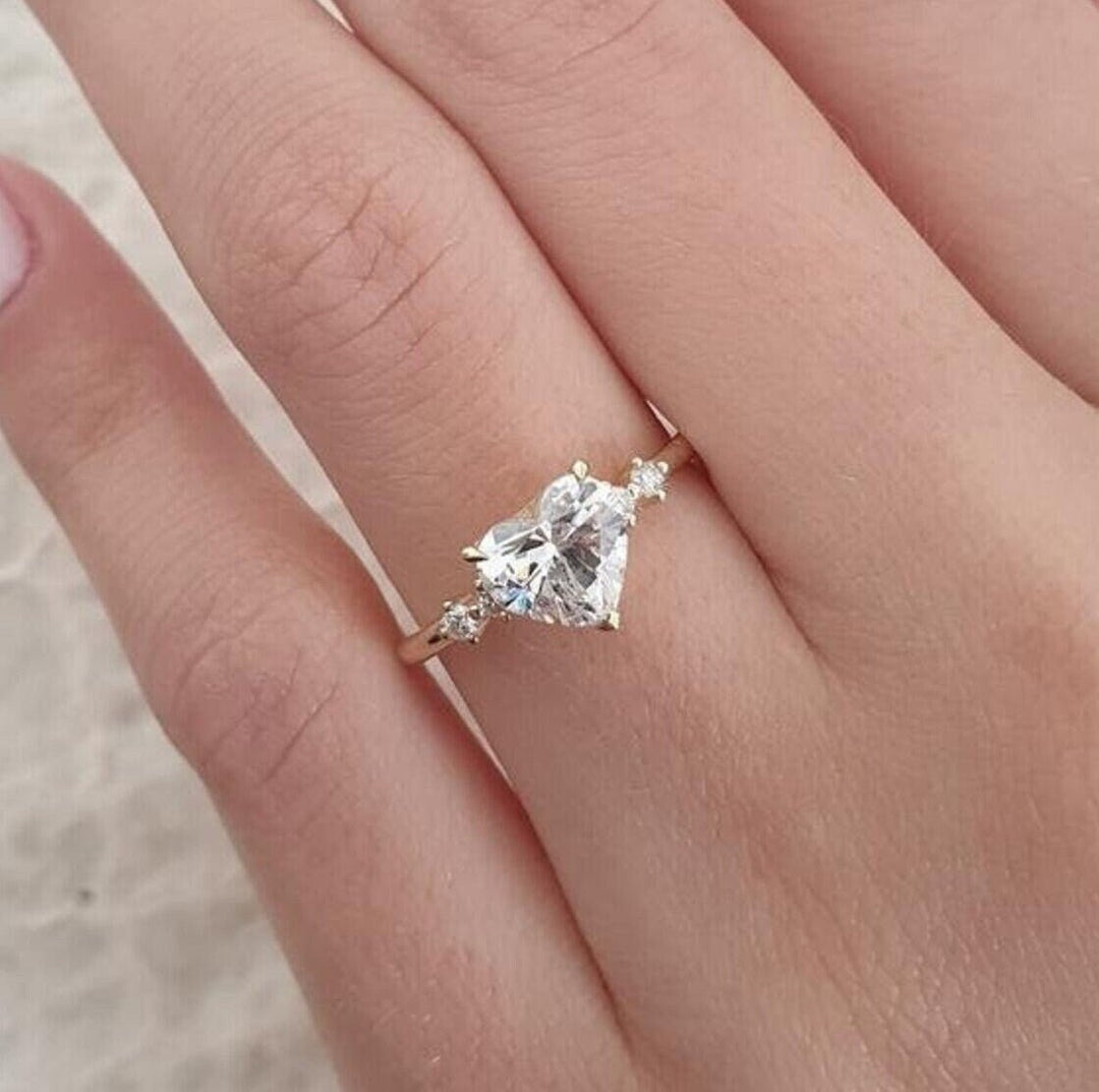 Certified heart cut diamond featured in five stone engagement ring