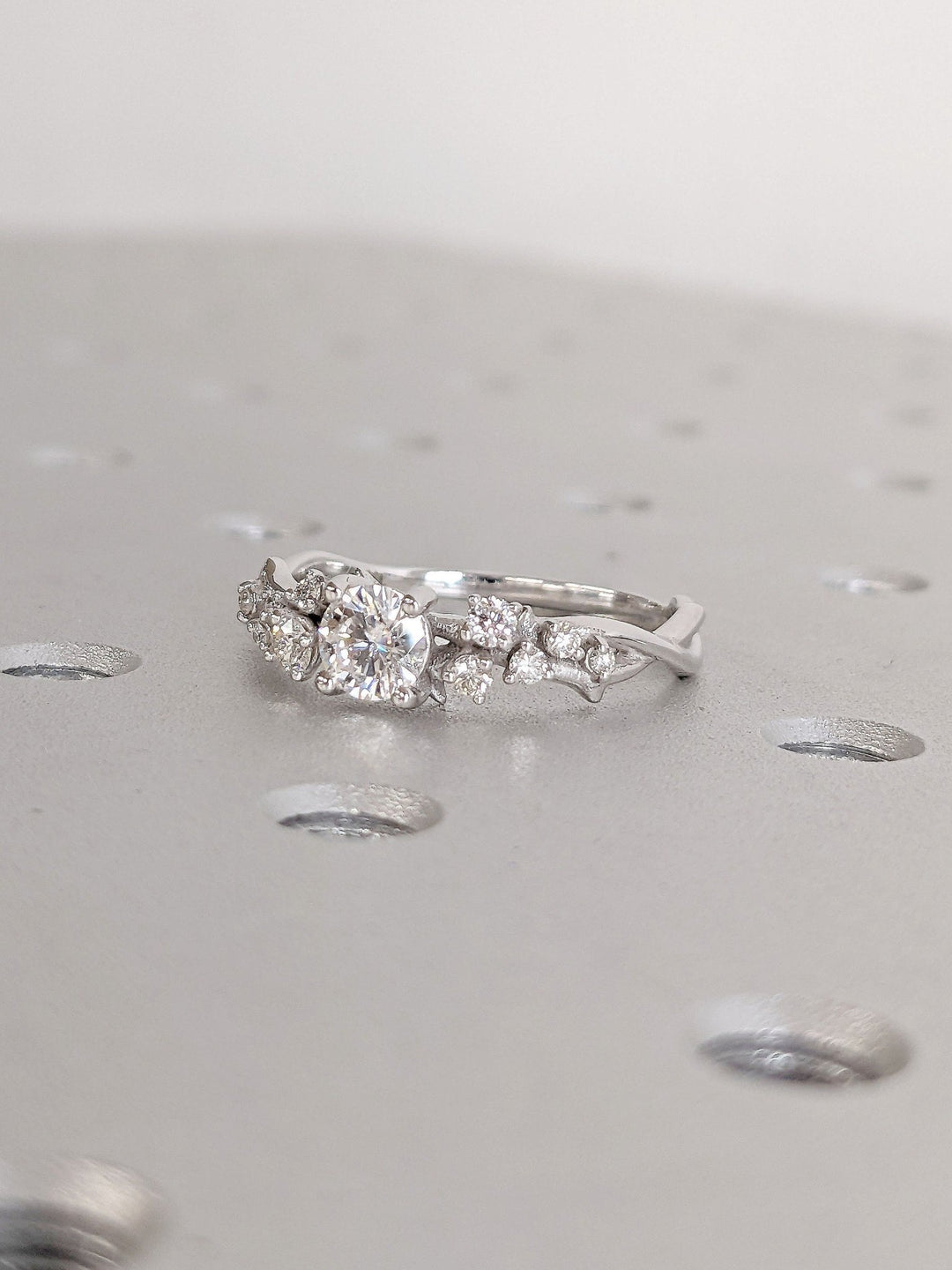 Round cut cluster engagement ring with IGI certified center diamond