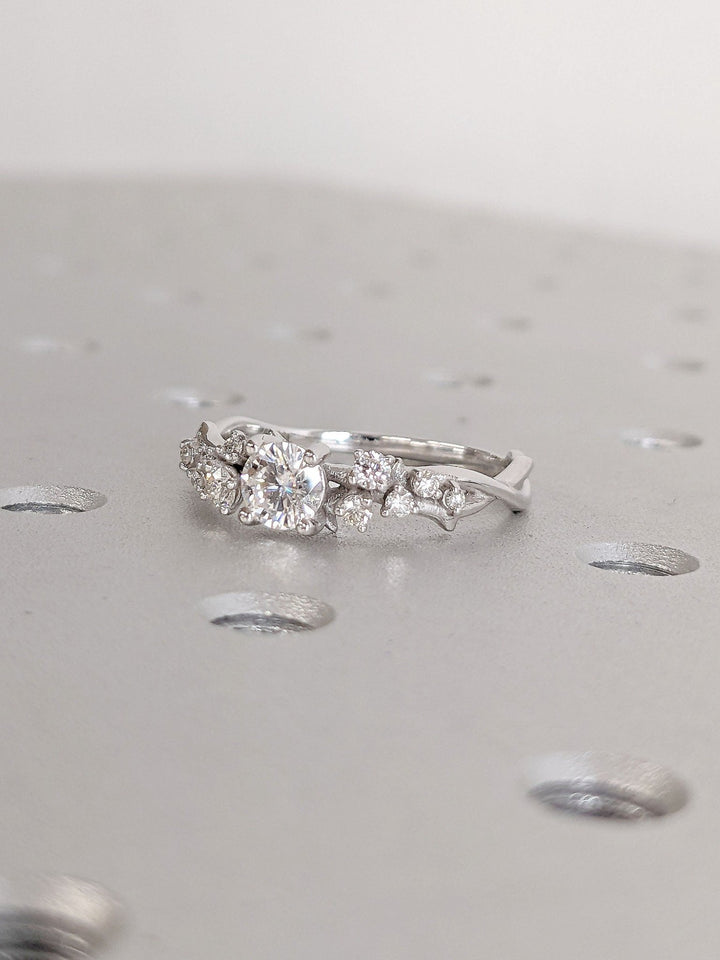 Round cut cluster engagement ring with IGI certified center diamond