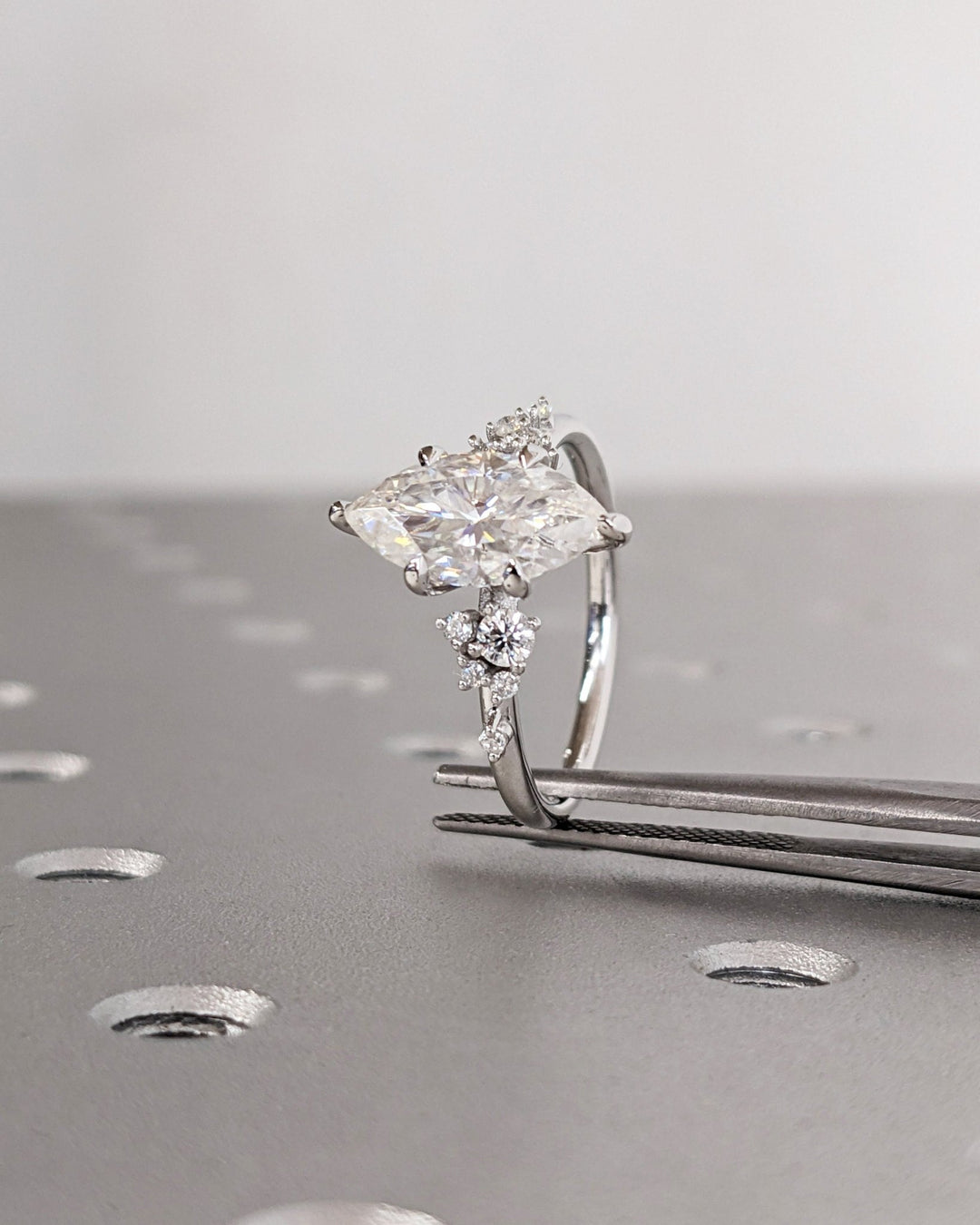 Marquise cluster ring set with an IGI graded diamond