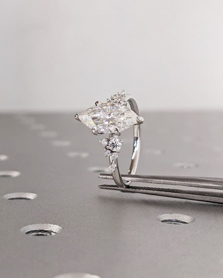 Marquise cluster ring set with an IGI graded diamond