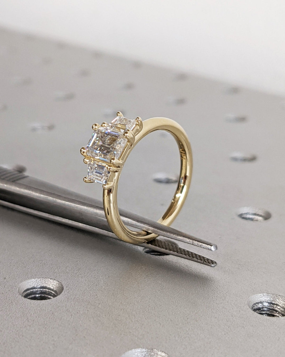 Macro shot of emerald cut diamond facets in solitaire ring setting