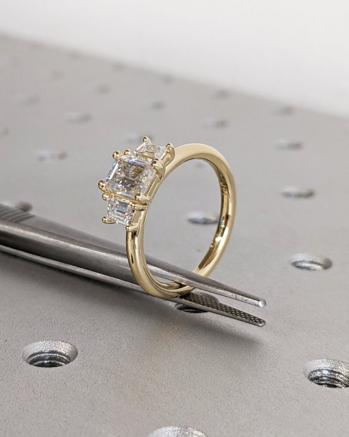 Macro shot of emerald cut diamond facets in solitaire ring setting