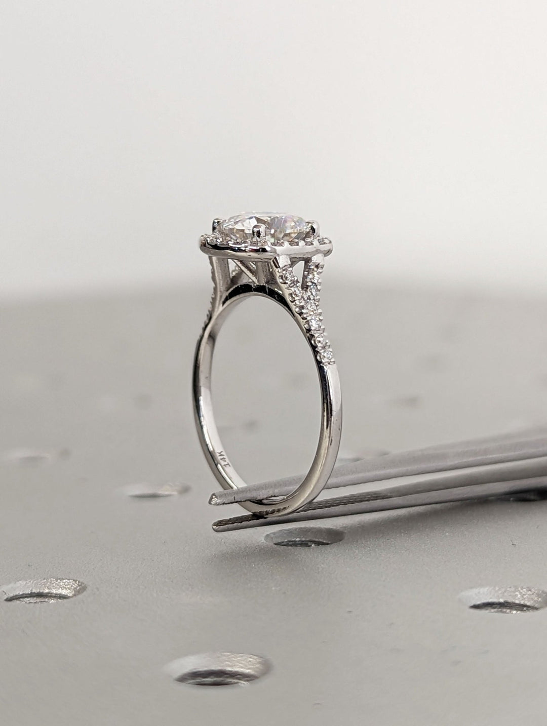 Round cut engagement ring shown with authenticity certificate