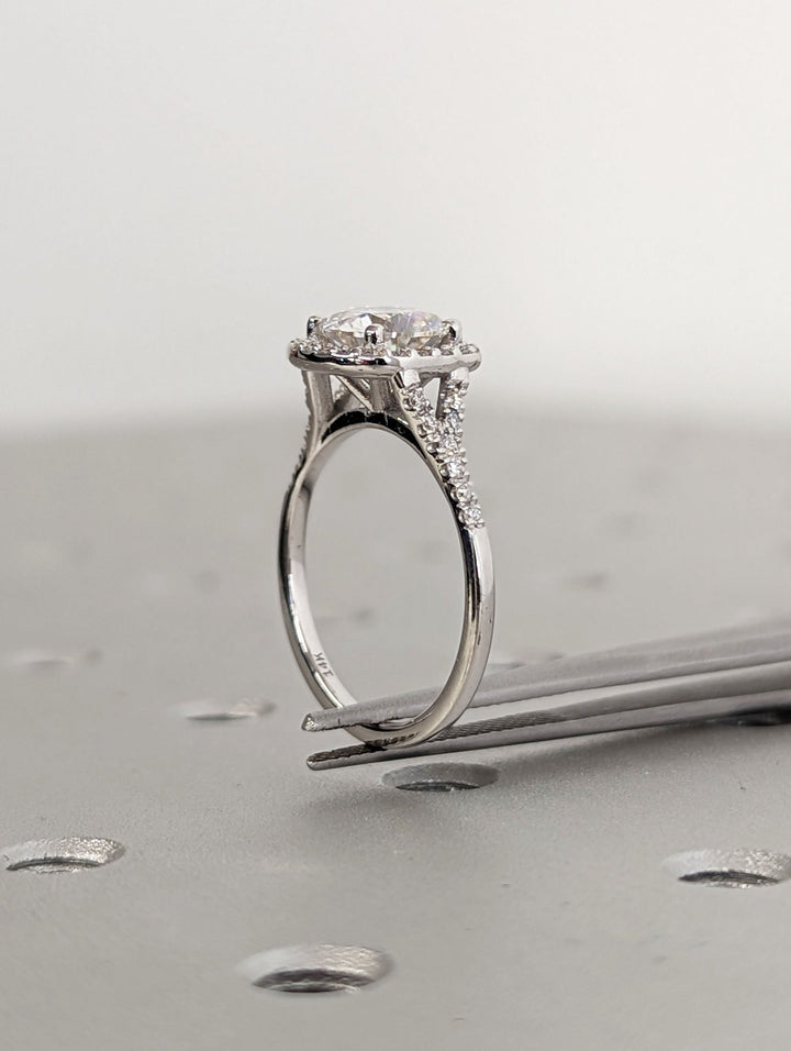 Round cut engagement ring shown with authenticity certificate