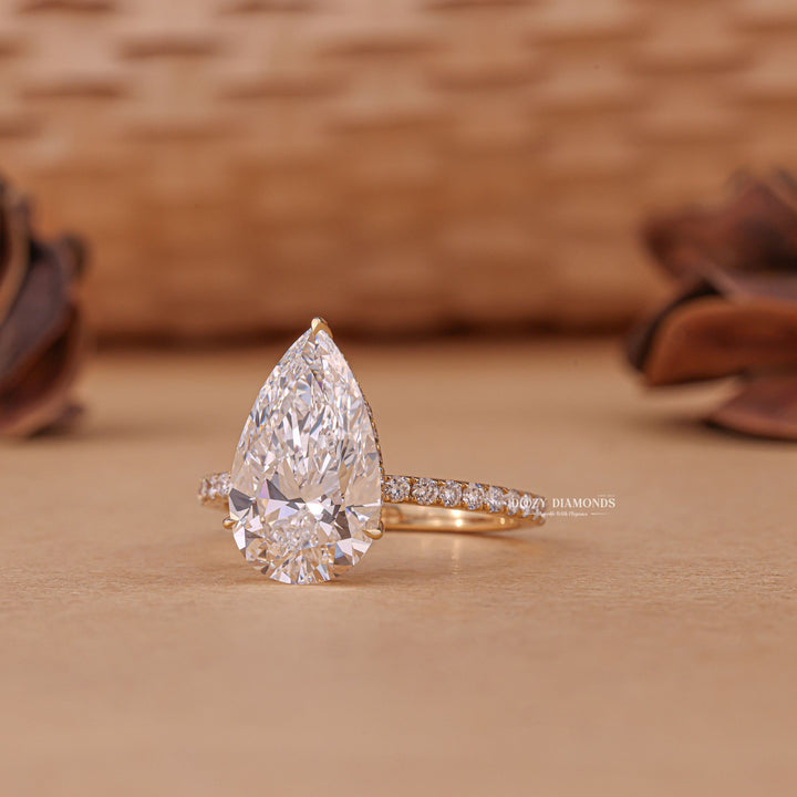Pear hidden halo lab grown diamond ring fitted on finger