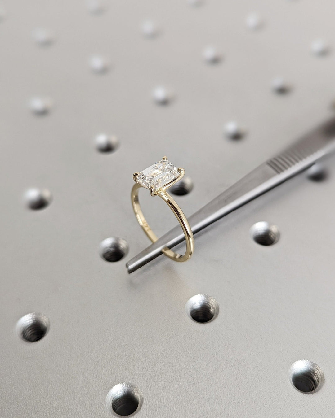 Emerald cut solitaire engagement ring shown in real-life wear