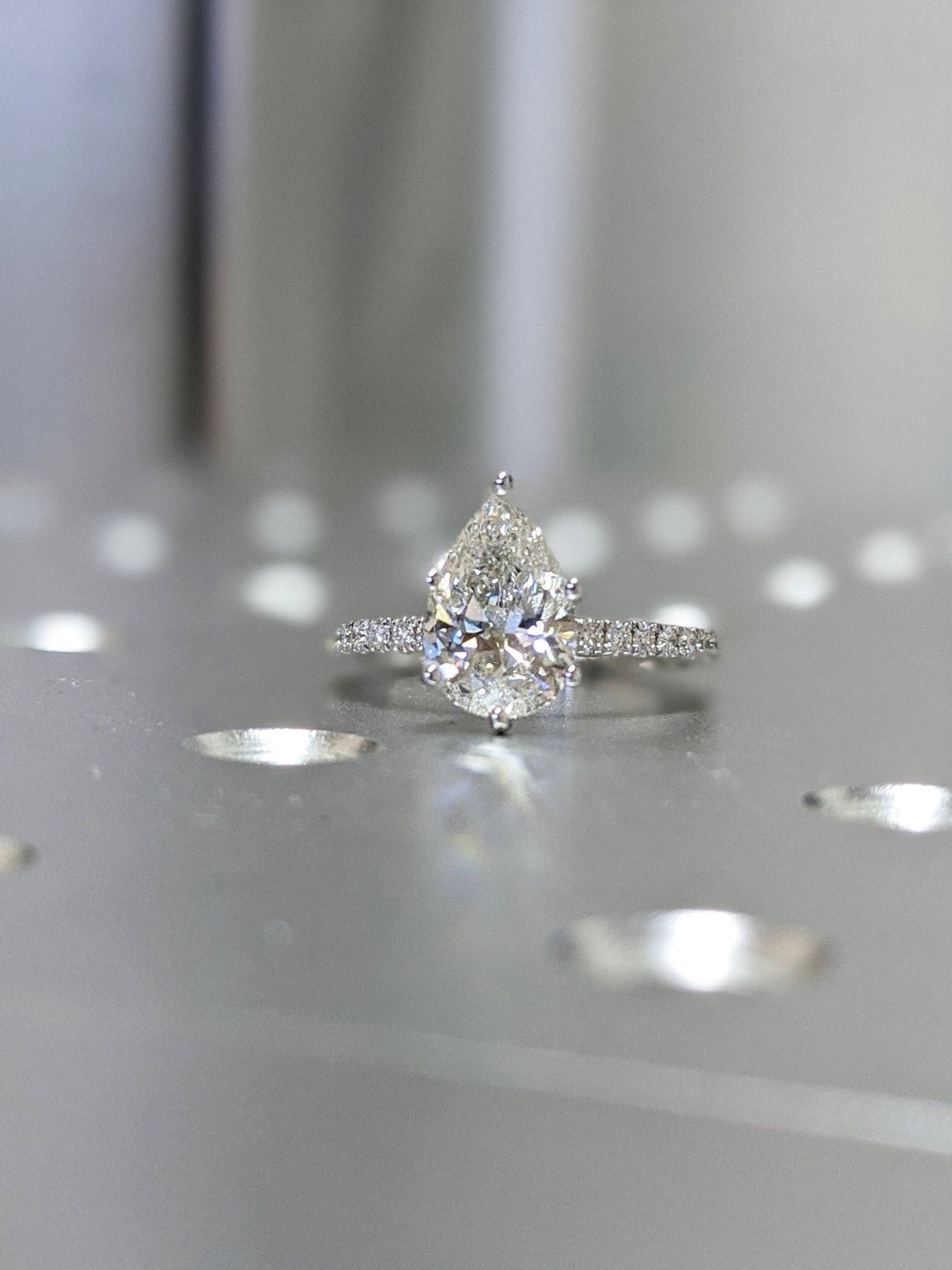 IGI certified pear cut diamond in pave engagement ring setting