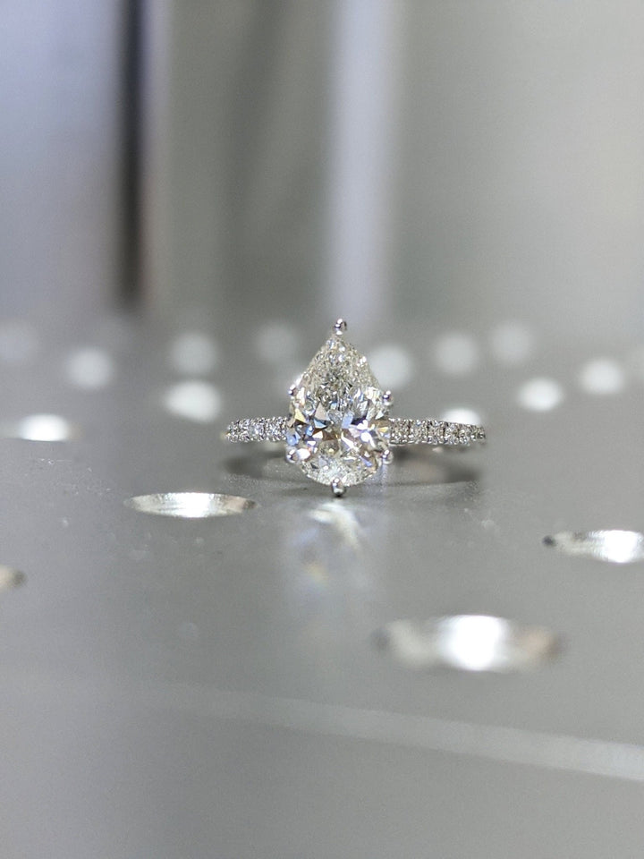IGI certified pear cut diamond in pave engagement ring setting