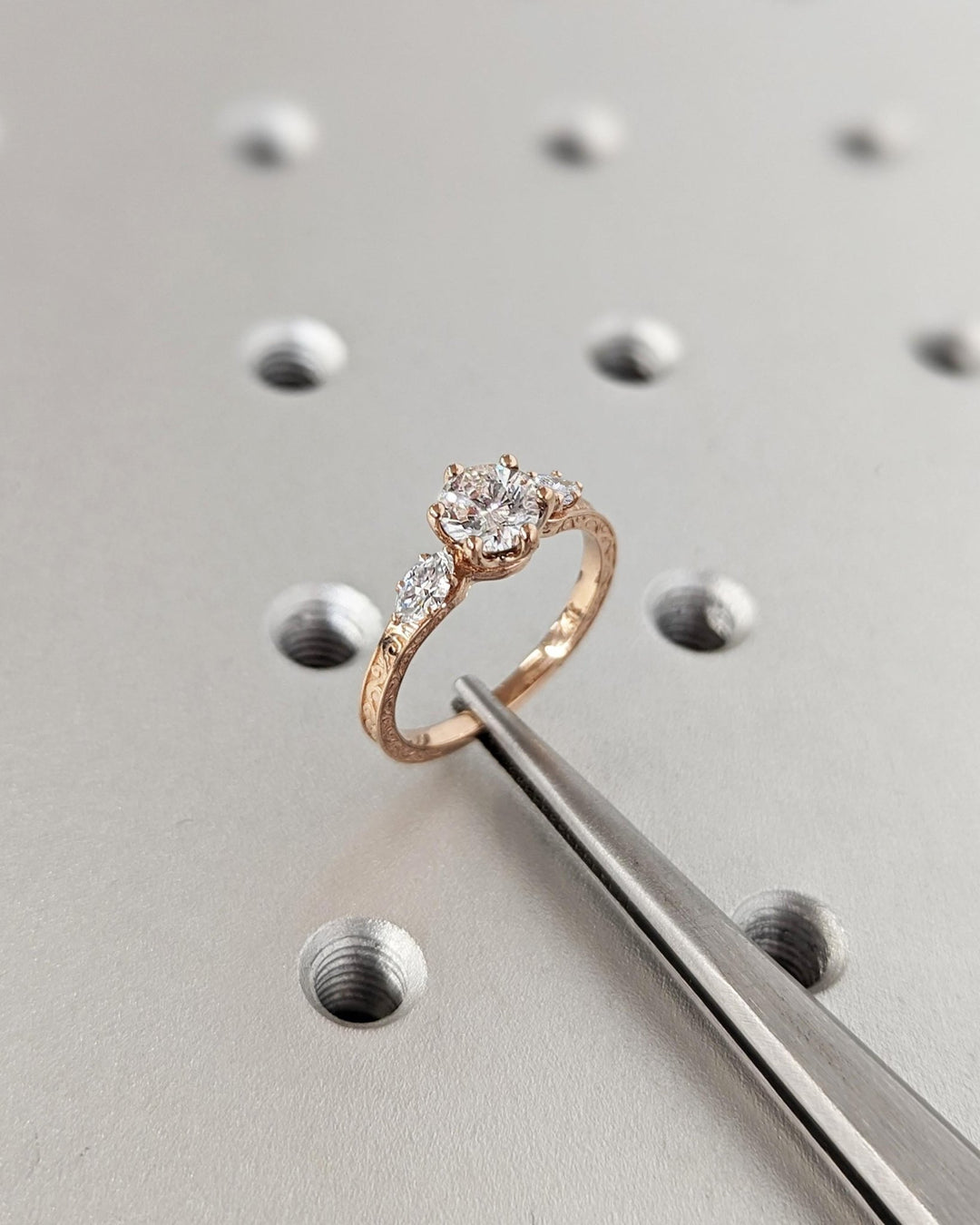 Round three stone engagement ring offered in gold and platinum