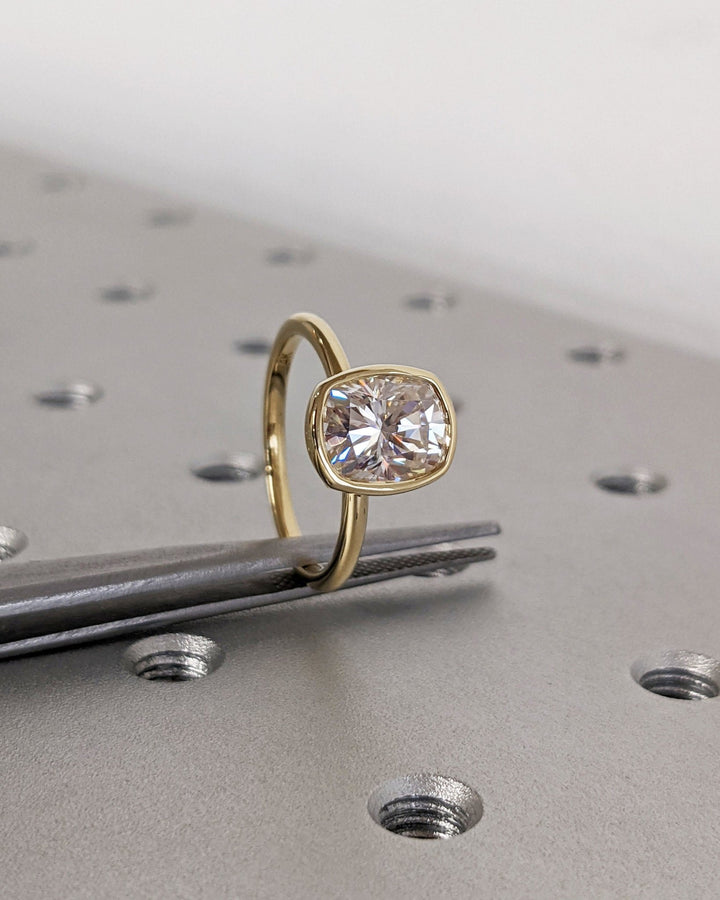Cushion bezel lab grown diamond ring fitted on finger