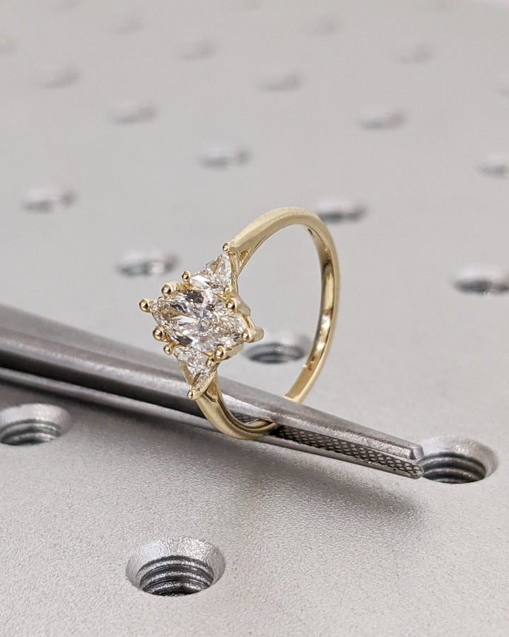 Marquise solitaire lab grown diamond ring side profile in gold setting