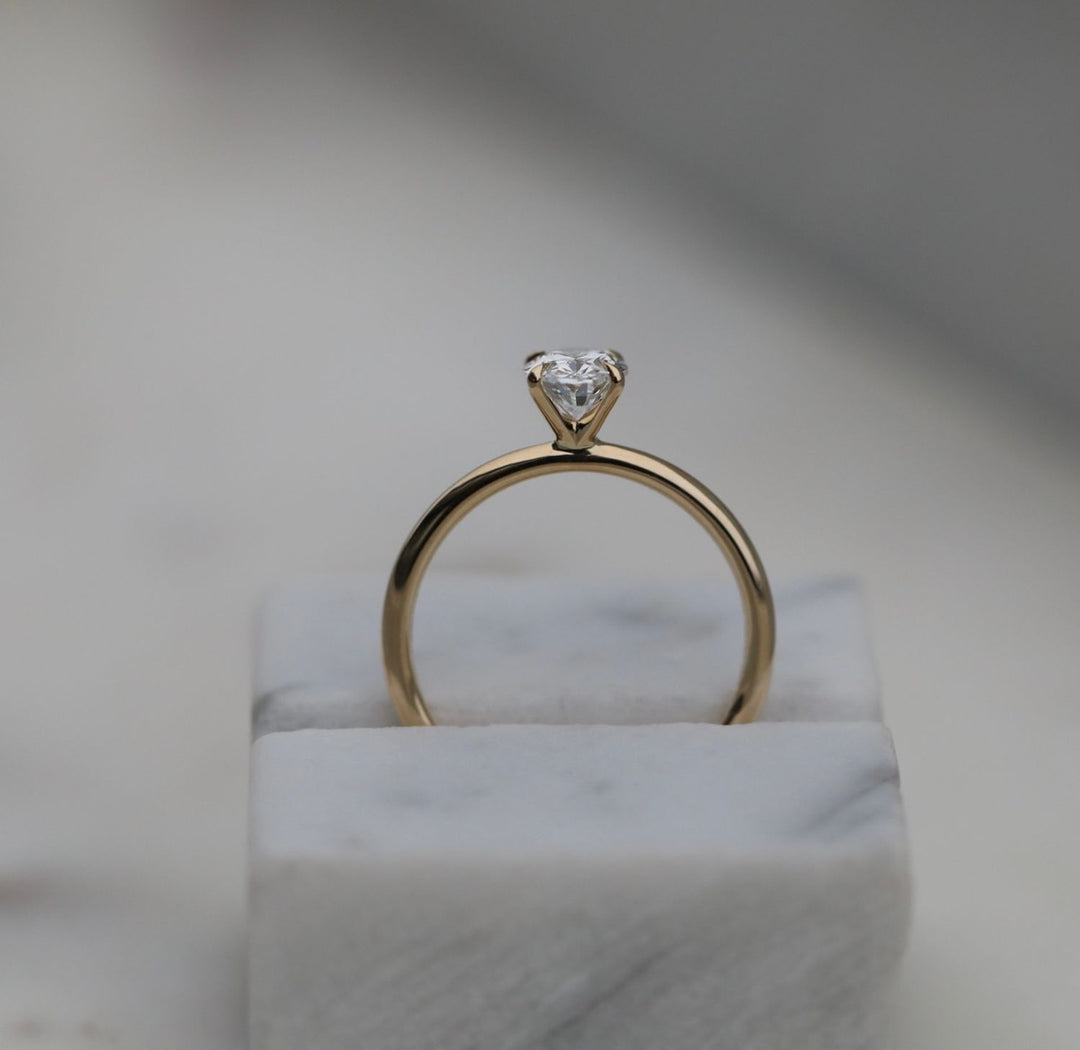 Oval solitaire engagement ring close-up highlighting diamond sparkle